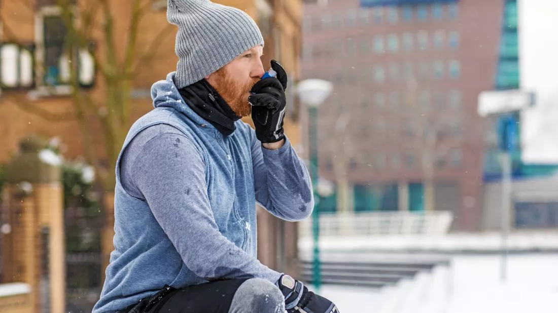 a-man-exercising-outside-and-using-an-inhaler-to-treat-his-asthma